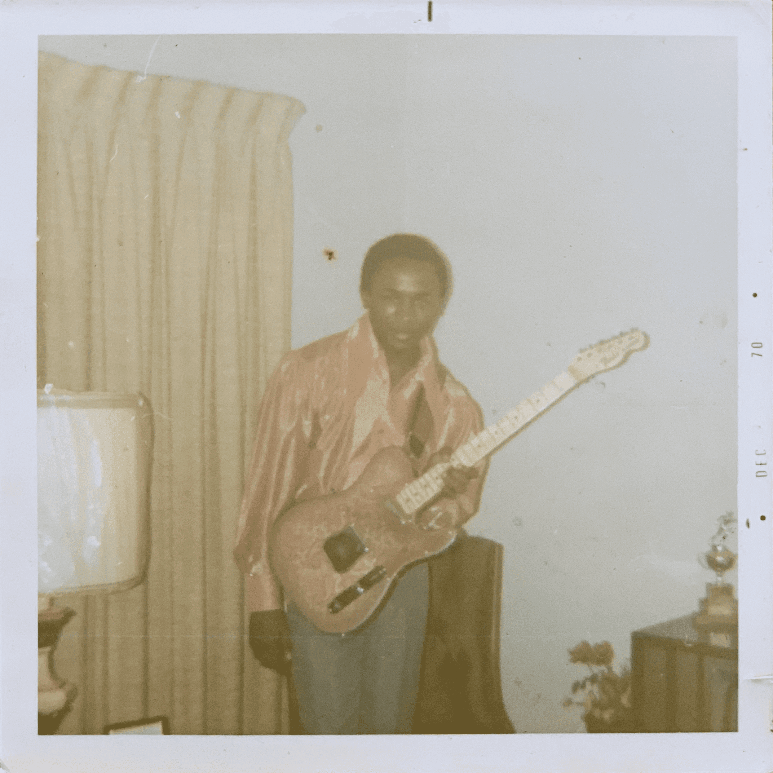 Robert D. Palmer with his first guitar. Photograph from the Palmer family archive.